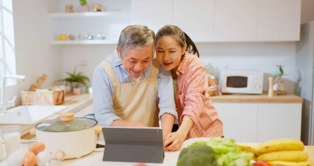 istock Asian elderly couple in kitchen 1854898082