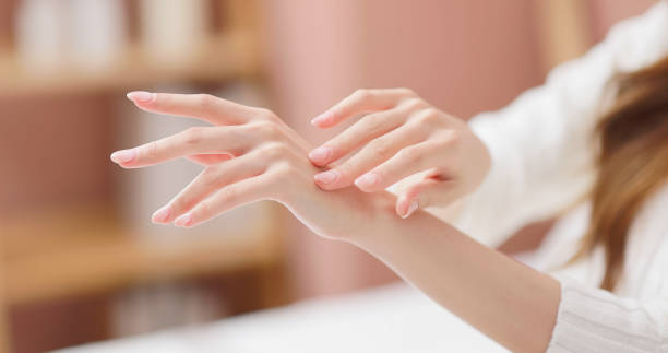 asian female skincare hand Closeup side view of asian female skincare caress hand and nail in autumn and winter human finger stock pictures, royalty-free photos & images