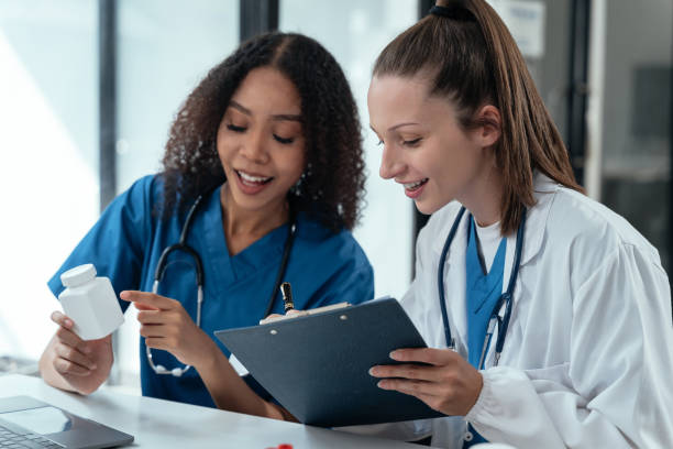 istock Pharmacists or doctors study information about tablets in the room in the evening. 1854948820
