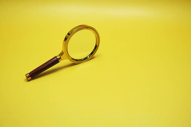 istock magnifying glass with space for copy top view on yellow background 1854958956