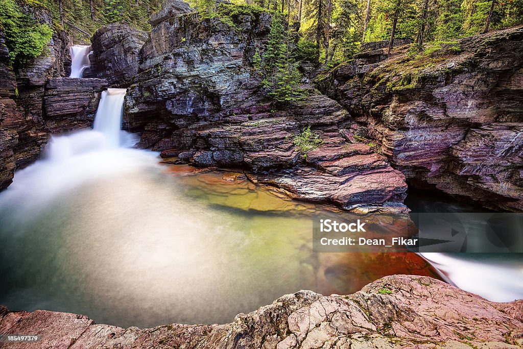 St. Mary Falls Red rocks and turquoise colored water at St. Mary's Falls in Glacier National Park, Montana US Glacier National Park Stock Photo