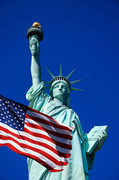 istock Statue of Liberty and USA flag 185497439