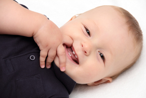 A mother with a toddler baby does gymnastics, children sports and fitness, isolated on a white background. Woman mom and child do morning exercises lying. Kid aged one year