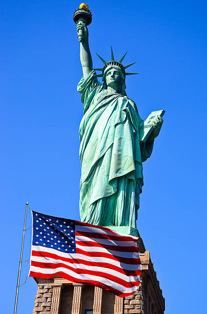 istock Statue of Liberty and US flag 185498160