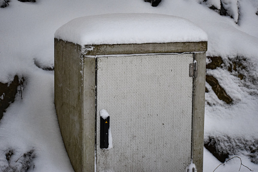An abstract image or background of an electricity box covered in snow
