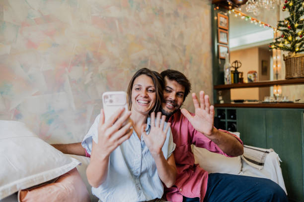istock Couple on a video call using mobile phone during Christmas at home 1855011998