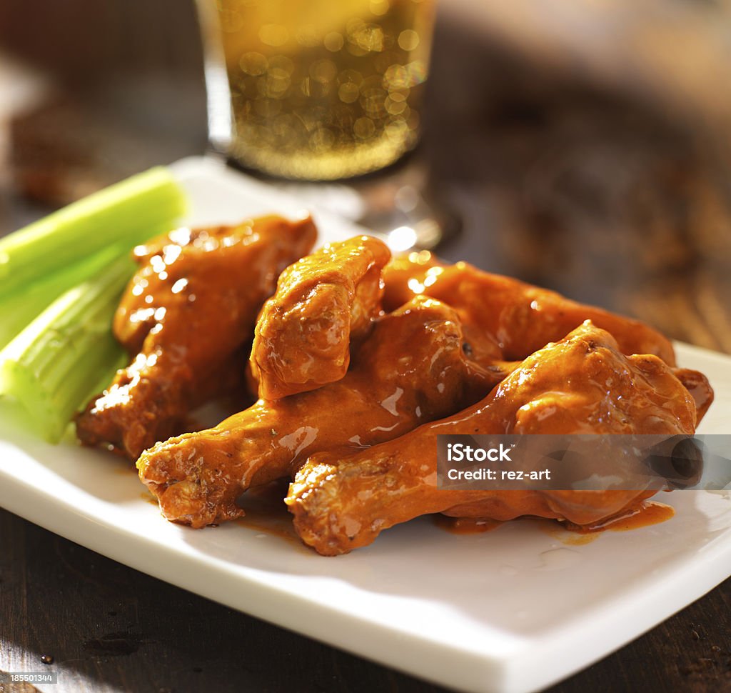 buffalo chicken wings with celery close up photo of a plate of buffalo chicken wings with celery. Shot with selective focus. Buffalo Chicken Wings Stock Photo