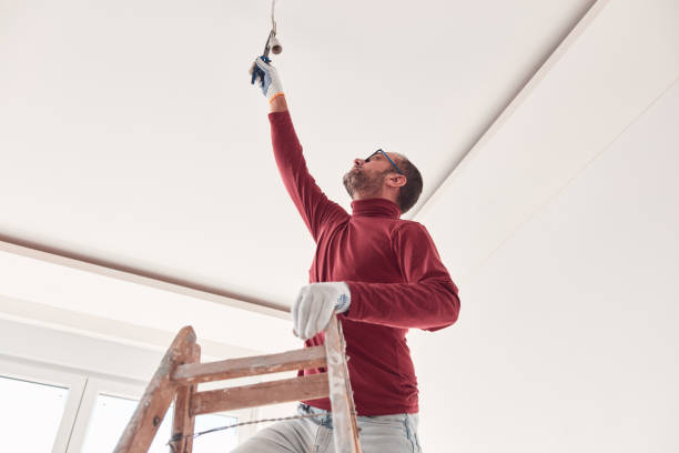istock Handyman electrician with ladders working in a new home interior. 1855014797