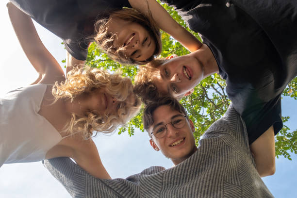 istock Group of young people try to form circle with arms 1855017526