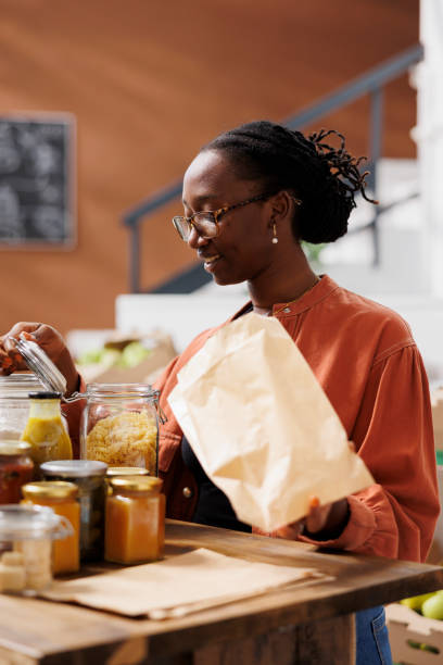 istock Customer looking at glass jar of pasta 1855018606