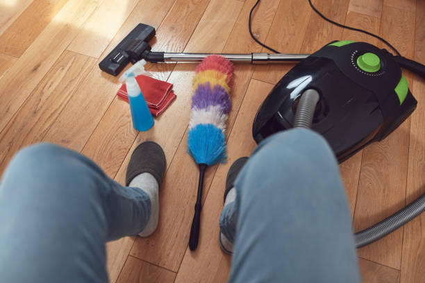 istock Man cleaning apartment with vacuum cleaner. 1855018645