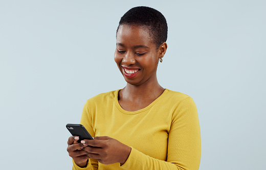 Happy black woman, phone and communication for social media against a blue studio background. Face of African female person smile on mobile smartphone for online chatting, texting or search on mockup