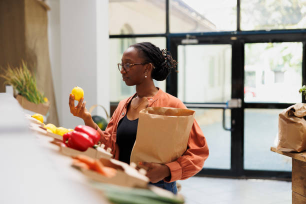 istock Black woman holding fresh lemon in store 1855022941