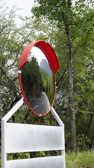 Outdoor traffic convex mirror in the hairpin bends and uphill road enroute to kodaikanal hilltop. Installed for improving safety.