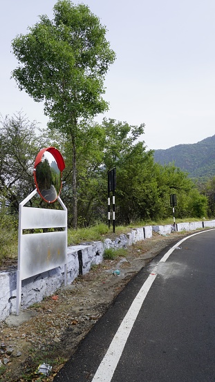 Outdoor traffic convex mirror in the hairpin bends and uphill road enroute to kodaikanal hilltop. Installed for improving safety.