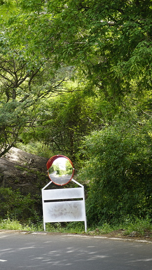 Outdoor traffic convex mirror in the hairpin bends and uphill road enroute to kodaikanal hilltop. Installed for improving safety.