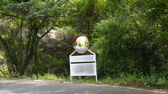 Outdoor traffic convex mirror in the hairpin bends and uphill road enroute to kodaikanal hilltop. Installed for improving safety.