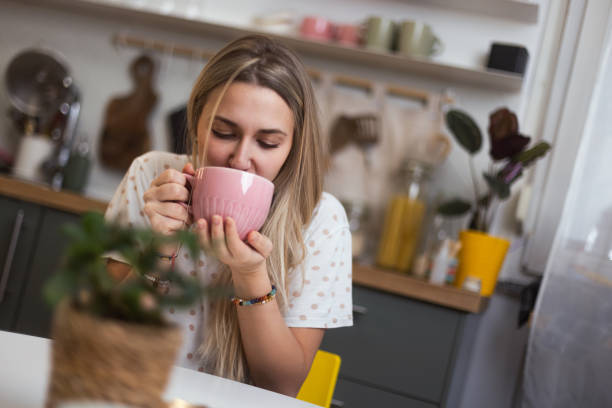istock A woman is sitting at the kitchen table and drinking her first morning coffee 1855039654