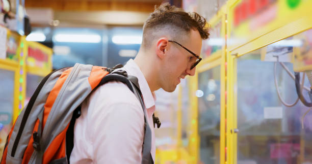 istock man visit claw machines shop 1855047420