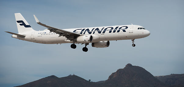 Tenerife, Spain December 10st, 2023. Airbus A321-231 Finnair Airlines flies in the blue sky. Landing at Tenerife Airport