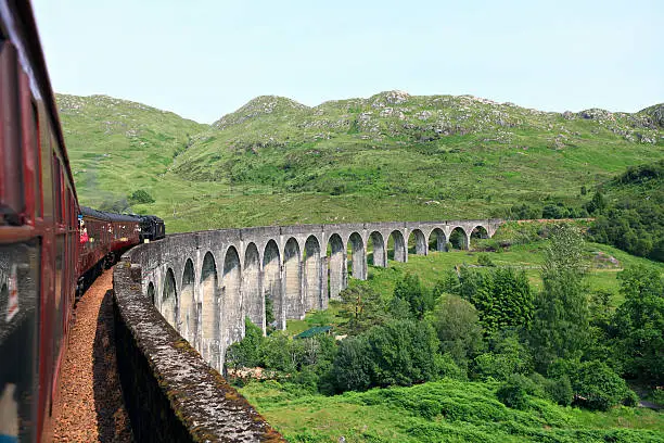 Train crossing the Glenfinnan viaduct. Scotland.