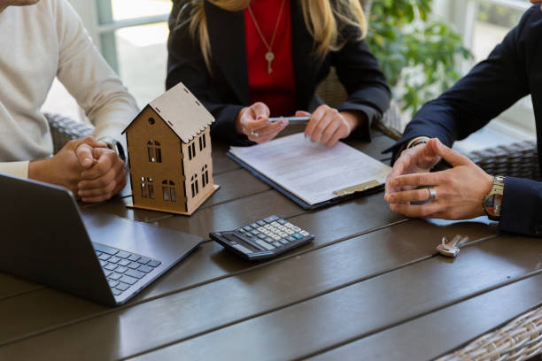 istock Estate agent and potential clients discuss available offer 1855057502