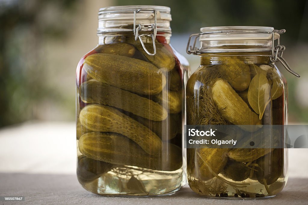 Glass jars of homemade canned  cucumbers on the outdoors kitchen Cucumber Stock Photo