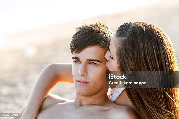 Girl Kissing Boy At Sunset Stock Photo - Download Image Now - Teenage  Couple, Beach, Kissing - iStock