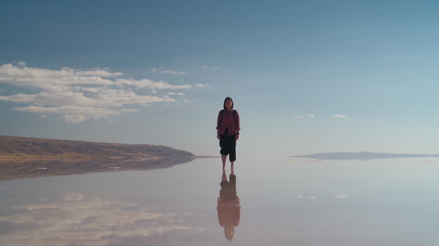Portrait of Asian female tourist in salt lake in Turkiye Turkey