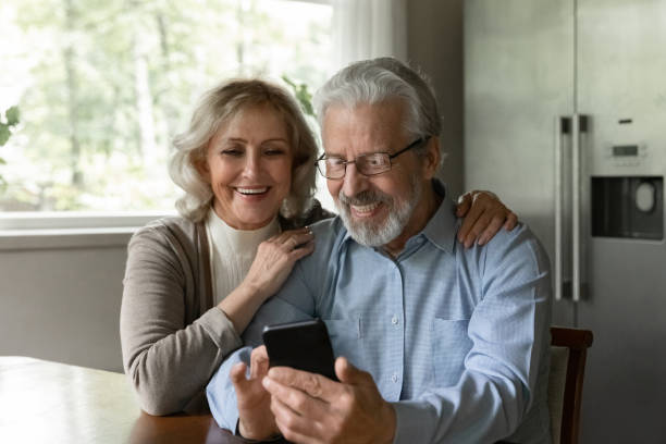 istock Curious aged wife watch husband playing game on mobile phone 1855117607
