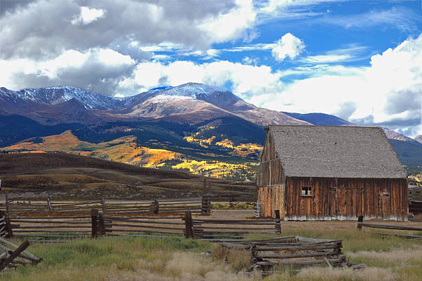 Weathered Barn near Leadville Colorado Weathered barn, fence in foreground, fall aspens in background, near Leadville Colorado leadville stock pictures, royalty-free photos & images