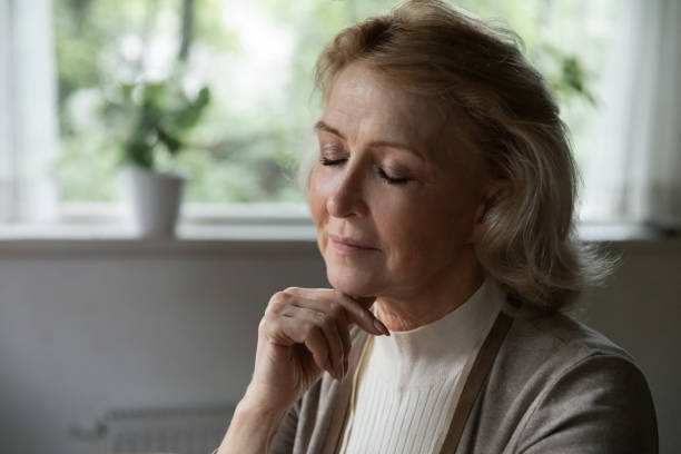 istock Elegant peaceful aged lady relaxing dreaming with closed eyes 1855124421