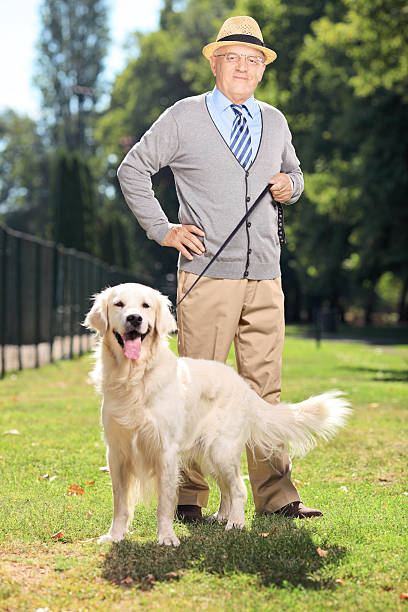 istock Senior man and his dog posing in the park 185514185
