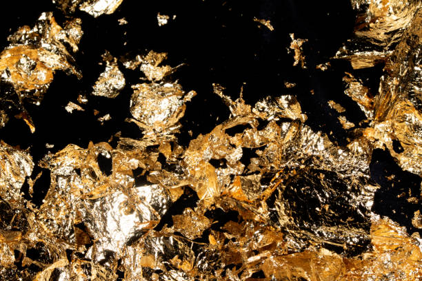 istock Gold Leaf Pieces Close Up on A Black Background as Decorative Pieces 1855186805