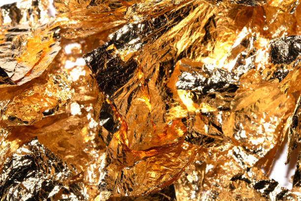 istock Gold Leaf Pieces Close Up on A White Background as Decorative Pieces 1855186807