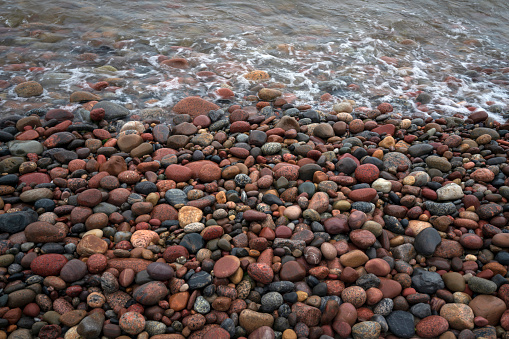 Background of multicolored sea pebbles on the shore of the Baltic Sea, Svetlogorsk, Kaliningrad region, Russia