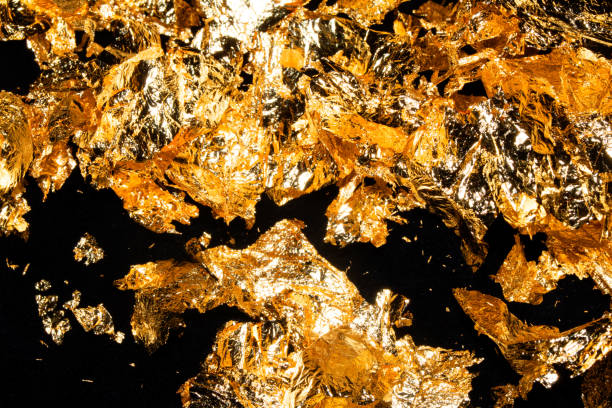 istock Gold Leaf Pieces Close Up on A Black Background as Decorative Pieces 1855188923