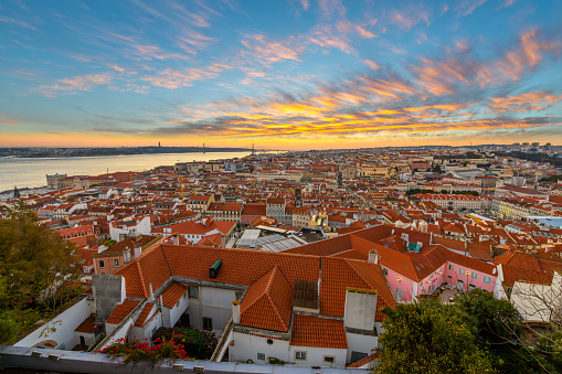 Sunset view from the Alfama district's Saint George Castle, or Castelo de São Jorge overlooking the old town historic center Baixa and Bairro Alto districts of Lisbon, Portugal.