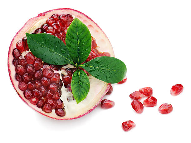 istock Pomegranate fruit with green leaves isolated on white background 185524716