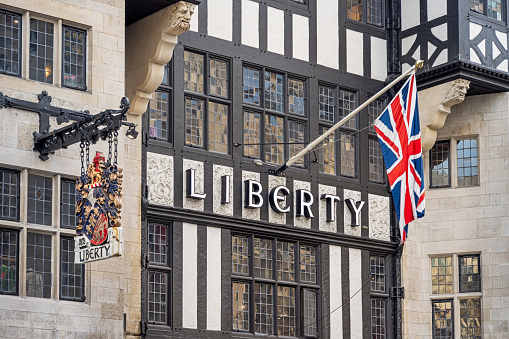 Great Marlborough Street, London, England - October 29th 2023:  Facade of a old half-timbered building with the word Liberty and a Great Britain national flag, the Union Jack