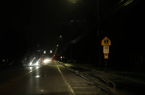 istock School Crossing Ahead Sign in the Dark in Canada 1855268493