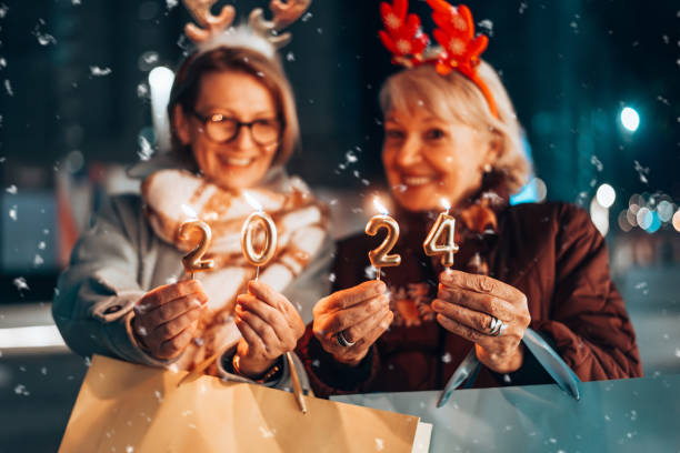 Two beautiful senior women celebrates Christmas's. stock photo