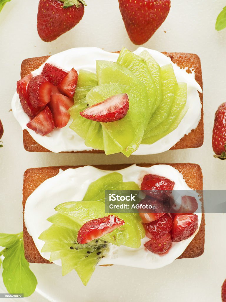 Cakes Coconut cakes with whipped cream, strawberry and kiwi. Viewed from above. Baked Stock Photo