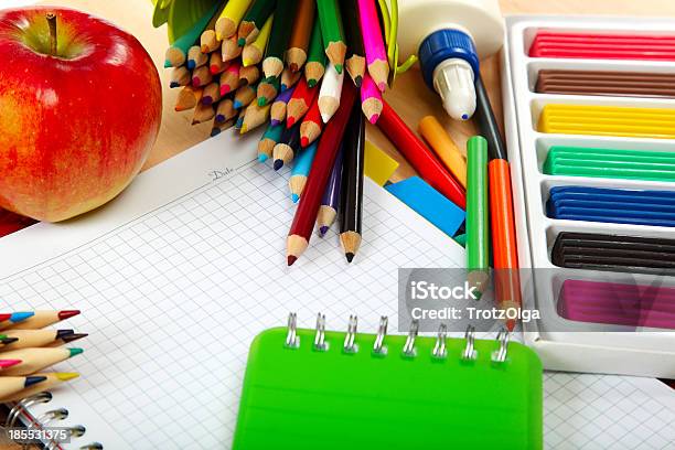 School And Office Supplies On A Wooden Table Stock Photo - Download Image Now - Address Book, Apple - Fruit, Box - Container