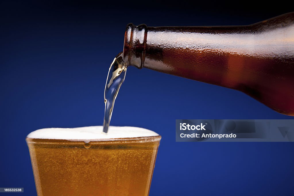 Pouring beer Beer is being poured in a glass. Beer - Alcohol Stock Photo