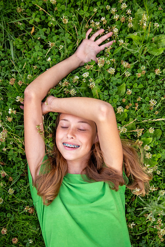 Happy laughing girl on grass. Smiling one child outdoors