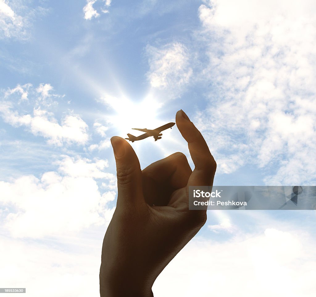 airplane in hand airplane in hand on sky background Air Vehicle Stock Photo