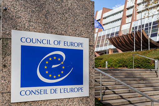 Strasbourg, France - November 11, 2023: The Council Of Europe sign with Logo next to the stairs leading to the entrance of the Council of Europe in Strasbourg, Bas-Rhin, Alsace, France. Strasbourg is seat of the European Parliament.