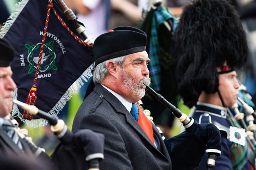 Bag Pipe bands parade around the fair grounds at the annual Highland games in Braemar. A classic display of Scottish culture and traditions. Braemar, Scotland