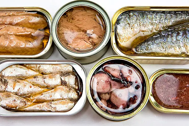 Photo of Tin cans full of seafood type foods like tuna and sardines